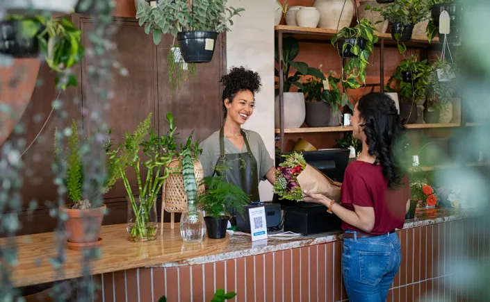 Woman checking out a customer at a store